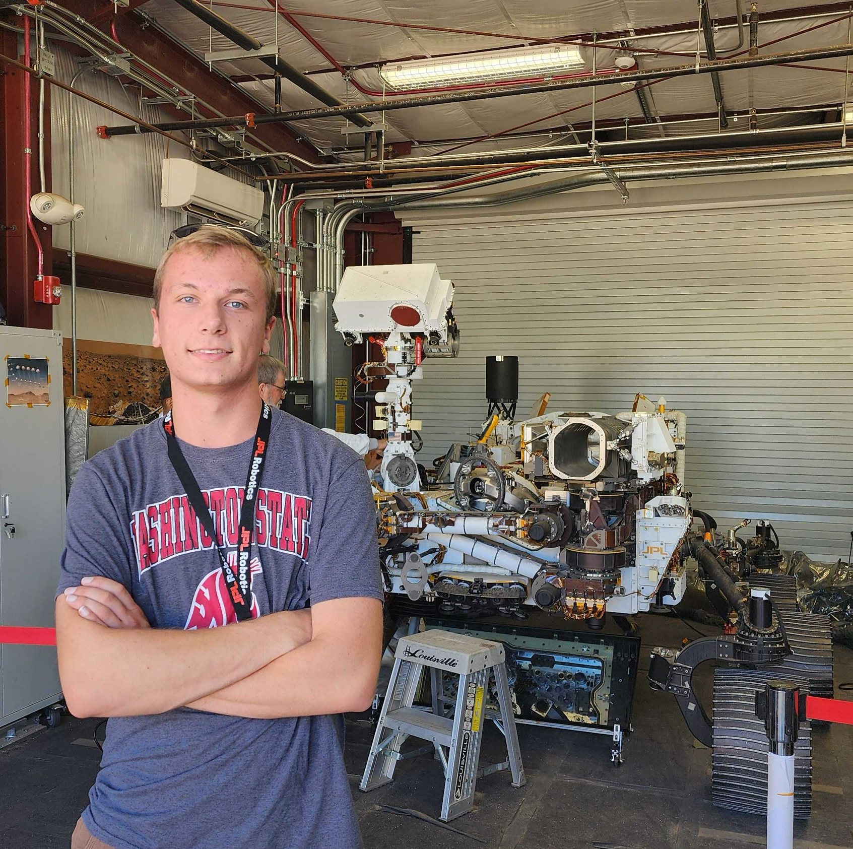 photo of author cole wilson standing in fron of rover model